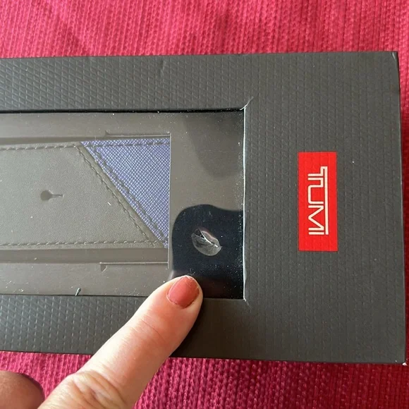 New in box Tumi leather strap- never removed from box - box has small damage
